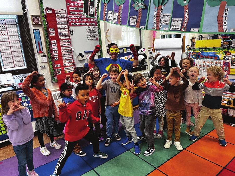 McGilvra kindergarten students and their teacher celebrating together in their classroom.